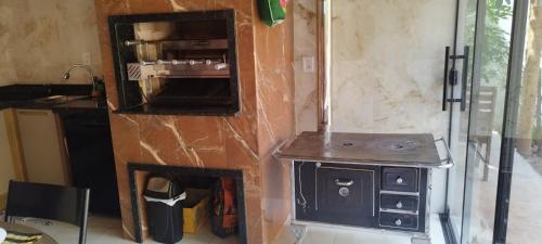 a small kitchen with a stove in a room at Espaço Moura in Chapada dos Guimarães