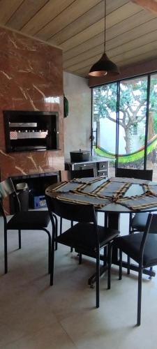 a dining room with a table and chairs and a fireplace at Espaço Moura in Chapada dos Guimarães