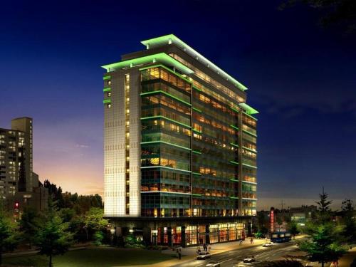 a tall building with lights on in a city at Prince Hotel in Gwangju
