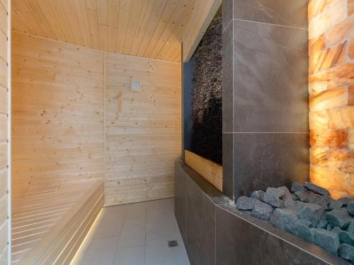 a bathroom with a sauna with wooden walls at Apartment in Pobierowo with Sea View in Pobierowo