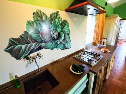 a kitchen with a large flower mural on the wall at Apartment near Lake Trasimeno vineyards in Strada