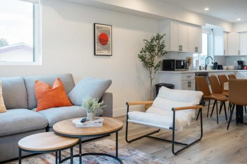 a living room with a couch and a table and chairs at Urban Oasis in the Heart of LA Near USC & Major Attractions in Los Angeles