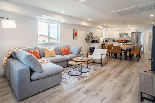 a living room with a couch and a table at Urban Oasis in the Heart of LA Near USC & Major Attractions in Los Angeles