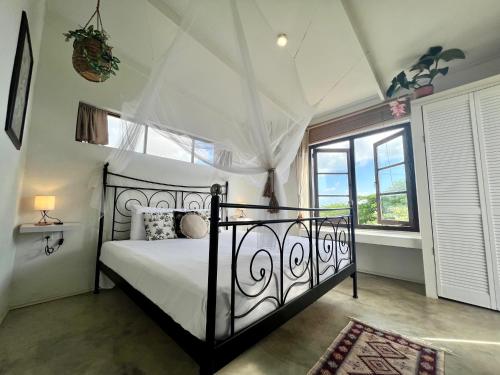 a bedroom with a bed and a window at The Octopus Tropical Oasis in Sint Michiel