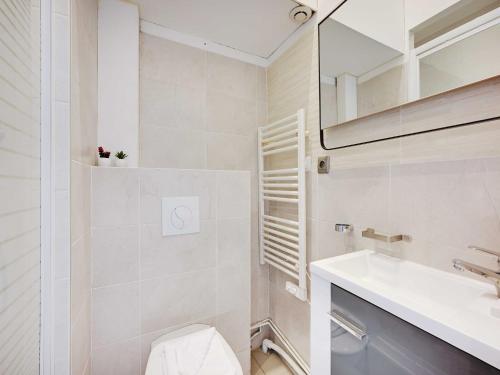 une salle de bain avec un lavabo, des toilettes et un miroir dans l'établissement Charming apartment -1BR 4P - Gare district, à Paris