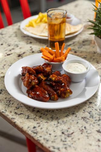 a plate of food with meat and carrots on a table at Hotel México Plaza Silao Aeropuerto in Silao