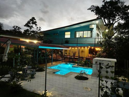 a house with a swimming pool in front of it at Azulita Oasis, Family-Sized Loft With Pool & Large Outdoor Areas in Aguas Zarcas