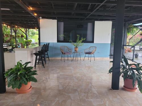 a patio with chairs and a table with plants at Azulita Oasis, Family-Sized Loft With Pool & Large Outdoor Areas in Aguas Zarcas