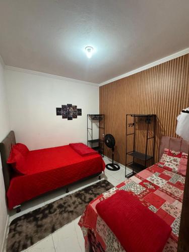 a bedroom with two beds and a red comforter at P nacional do catimbau Buíque de 1 a 10 hospeder in Catimbau