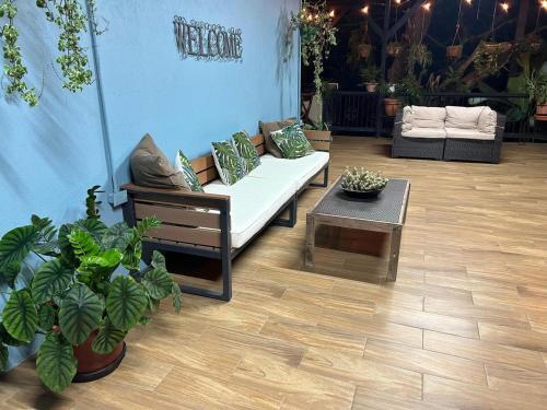 a living room with a couch and a coffee table at Azulita Oasis, Family-Sized Loft With Pool & Large Outdoor Areas in Aguas Zarcas