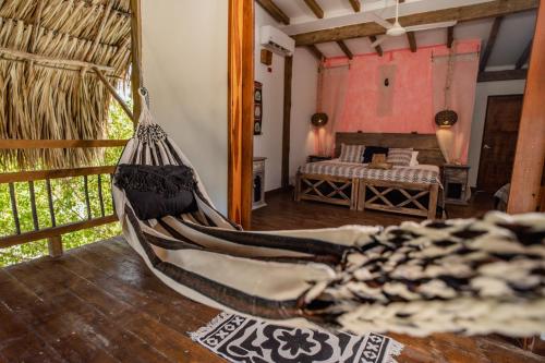 a hammock in a room with a bedroom at Casa del Mar by Al Alma in San Onofre