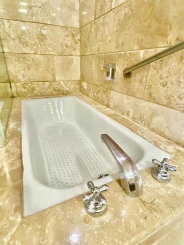 a white sink in a bathroom with a facet at Condos Privados en Huatulco in Tangolunda