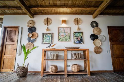 a room with a shelf and a wall with hats at Casa del Mar by Al Alma in San Onofre
