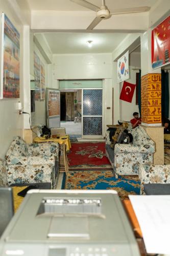 a living room with couches and a table at Grand Square Hostel Luxor in Luxor