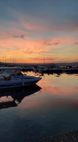 a boat is docked in a marina at sunset at Sunshine Alloggio turistico in Capodimonte