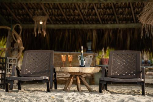 two chairs and a table with two candles on the beach at Casa del Mar by Al Alma in San Onofre