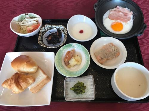 a tray filled with different types of breakfast foods at Business Hotel Kawakami in Kumano