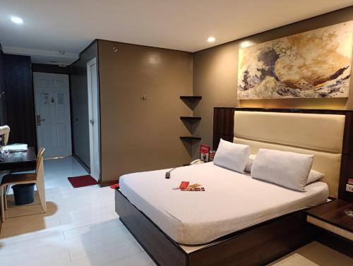 Postel nebo postele na pokoji v ubytování Hotel Sogo Malate