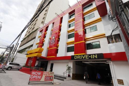 a facade of a building with a drive in sign at Hotel Sogo Malate in Manila