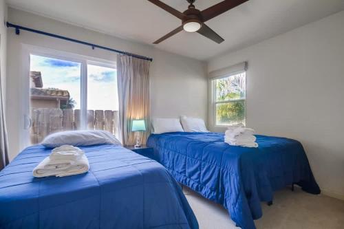 two blue beds in a room with a window at Best Ocean & Bay Views in SD Large Backyard Air Conditioning in San Diego