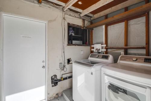 a laundry room with a washing machine and a window at Best Ocean & Bay Views in SD Large Backyard Air Conditioning in San Diego