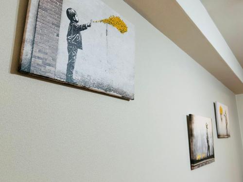 a painting of a boy hanging on a wall at 広島Riverside house第2ひまわり301号室 in Hiroshima