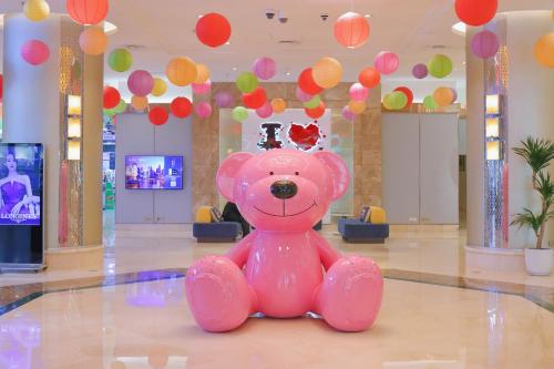 a pink teddy bear sitting in the middle of a room at JEN Shenyang by Shangri-La in Shenyang