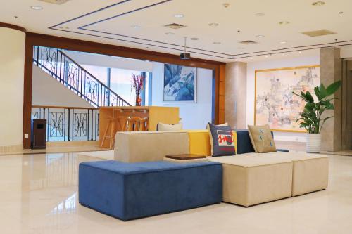 a living room with a blue couch in a lobby at JEN Shenyang by Shangri-La in Shenyang