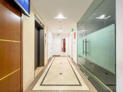 a corridor in a building with a glass wall at Hibiki Apartment in Hanoi