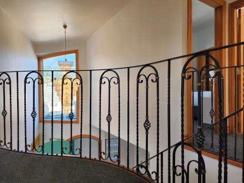 a staircase with a black wrought iron railing at U Suites on Courtenay in Wellington