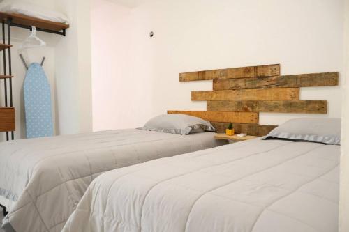 two beds sitting next to each other in a bedroom at Fifi House in Ciudad del Carmen