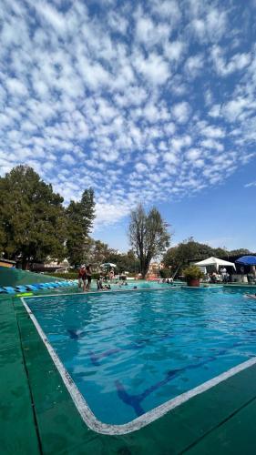 a large swimming pool with people in the water at Club Santa Maria in Cuernavaca