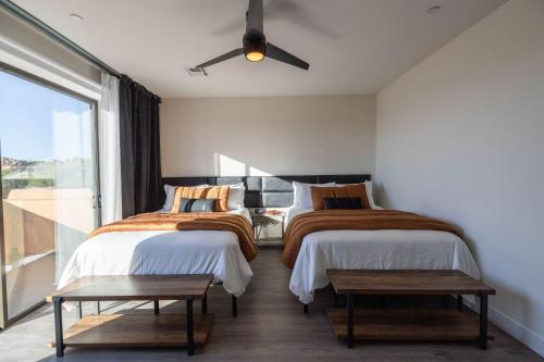 two beds in a room with a window at Villas 1, 2, 4 The Villas At Troon North in Scottsdale