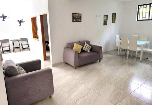a living room with two couches and a table at Apartahotel La Gruta in Jericó