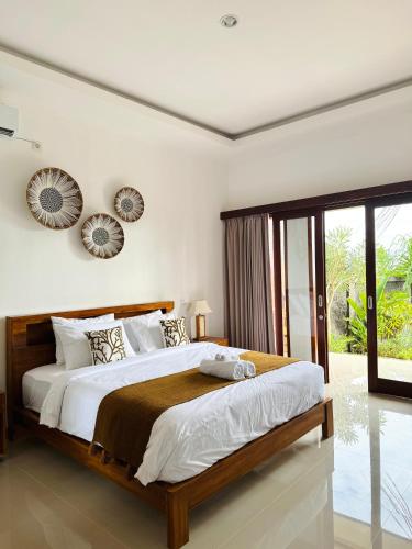 a bedroom with a large bed and a large window at South Hill Pandawa in Nusa Dua