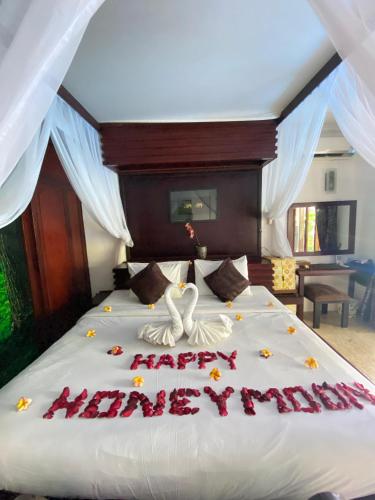 a bed with a happy new year written on it at Classic Villa with Private Pool in Kuta