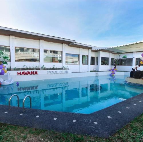 a large swimming pool in front of a building at Classic Villa with Private Pool in Kuta