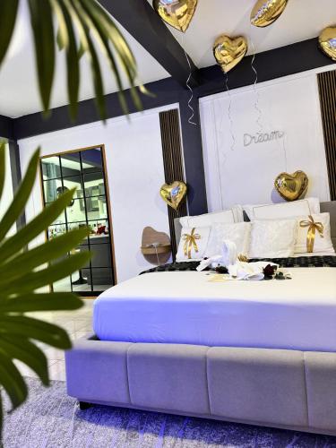 a bedroom with a large bed and a mirror at Sensoria Suit -Plaisir d'amour in Schœlcher