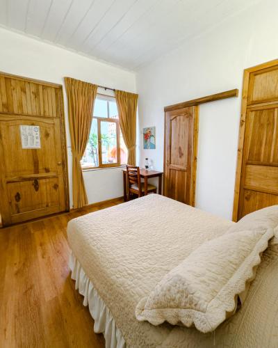 a bedroom with a large bed and a desk at Hotel Boutique Casa Montalvo Cuenca in Cuenca