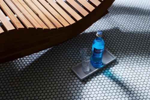 a bottle of water sitting on a stand next to a bench at Best Western Raphael Hotel Altona in Hamburg