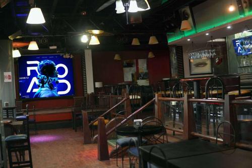 a restaurant with a tv in the middle of the room at Wyndham Garden Los Mochis Plaza Inn in Los Mochis