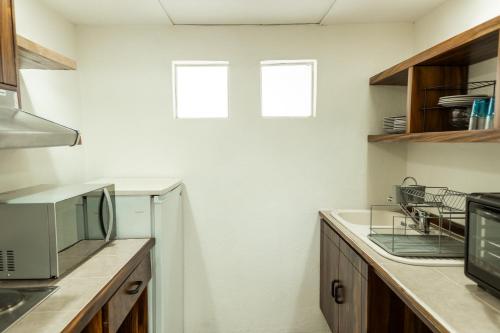 a kitchen with a sink and a microwave at Condos Privados en Huatulco in Tangolunda