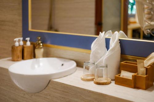 a bathroom sink sitting on a counter in a bathroom at Fourteen Roses Boutique Hotel, Kuta in Legian