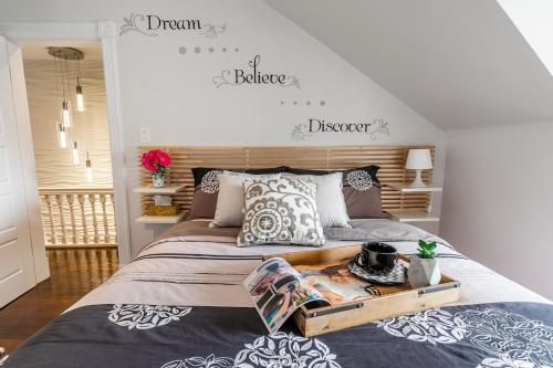 a bedroom with a large bed with a wooden headboard at Modern City Suite with Rooftop Patios in Toronto