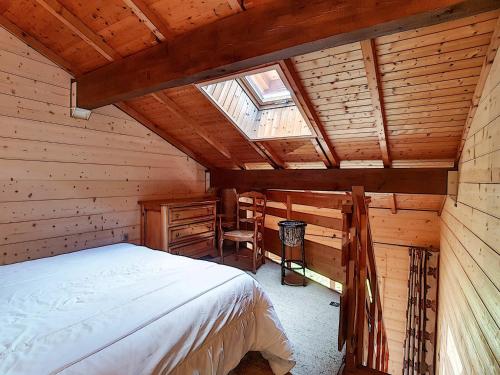a bedroom with a bed in a wooden cabin at La Clusaz: Duplex 4 pers, Animaux admis, Parking réservé - FR-1-818-90 in La Clusaz