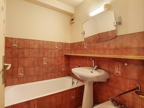 a bathroom with a sink and a tub and a mirror at La Clusaz: Duplex 4 pers, Animaux admis, Parking réservé - FR-1-818-90 in La Clusaz