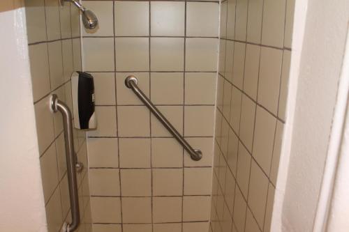a bathroom with a shower with two hand rails at Union Hotel in San Francisco