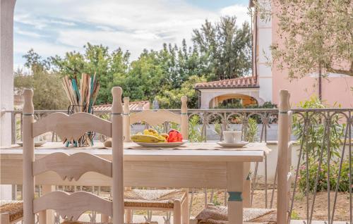 a wooden table with a bowl of fruit on a balcony at Bilo 5 in Orosei