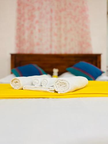 a bed with towels on top of it at Jm Resort in Dambulla