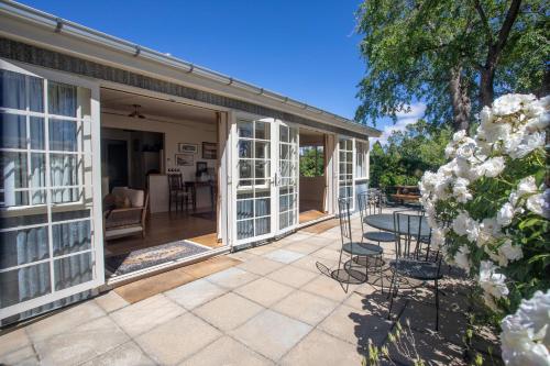 an open patio with a table and chairs on it at Aldourie Lodge - Lake Tekapo in Lake Tekapo
